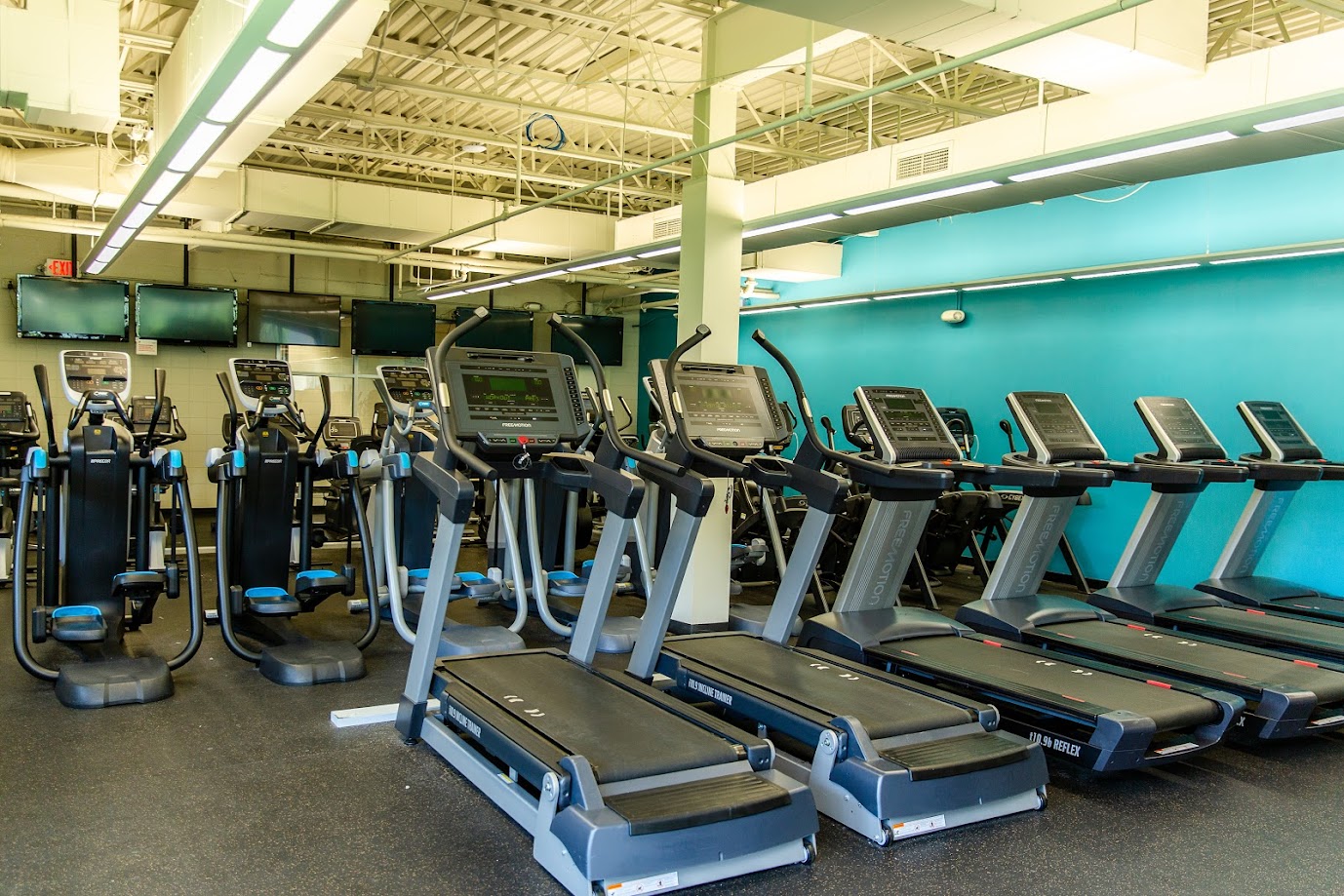 Southwest_Treadmills and Ellipital machines with tv screens in the background
